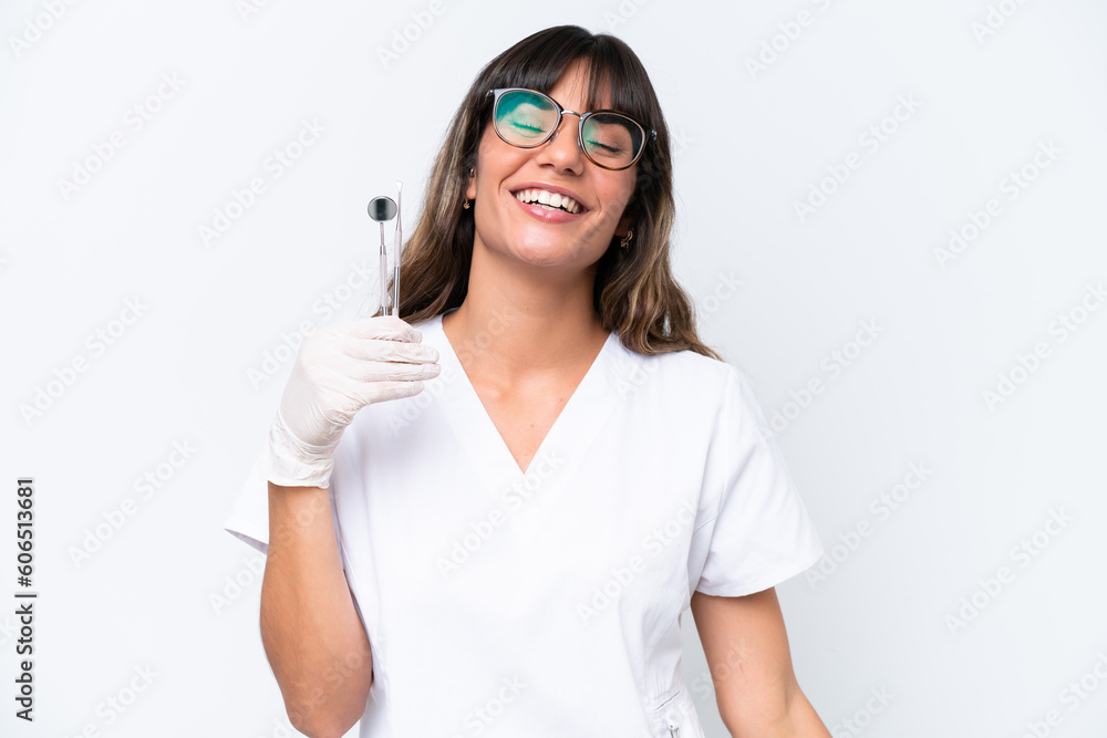 Dentist caucasian woman holding tools isolated on white background laughing Dentist caucasian woman holding tools isolated on white background laughing