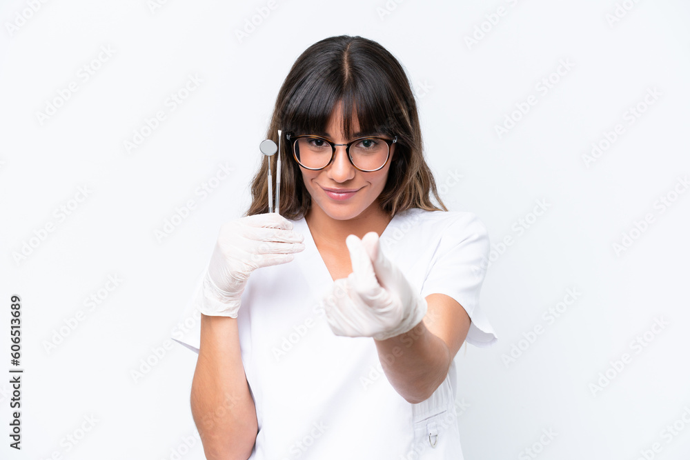 Dentist caucasian woman holding tools isolated on white background making money gesture Dentist caucasian woman holding tools isolated on white background making money gesture