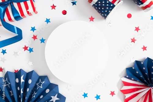 4th of July, USA Presidents Day, Independence Day. Paper empty round podium, platform, paper fan, gift with bow, confetti paper cups on white background, party, celebration holiday. Flat lay, top view