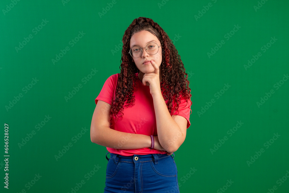 Teenager with red curly hair, wearing jeans, shirt, glasses and with various facial expressions of feelings Teenager with red curly hair, wearing jeans, shirt, glasses and with various facial expressions of feelings