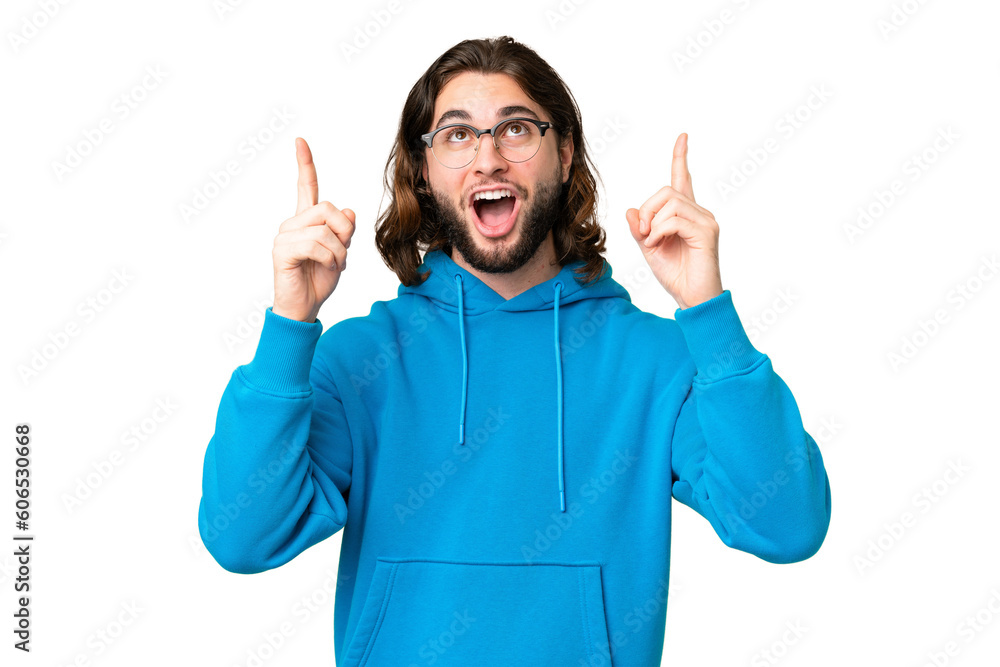 Young handsome man over isolated chroma key background surprised and pointing up Young handsome man over isolated chroma key background surprised and pointing up