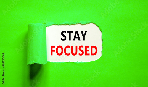 Stay focused symbol. Concept words Stay focused on beautiful white paper on a beautiful green background. Business, support, motivation, psychological and stay focused concept. Copy space.