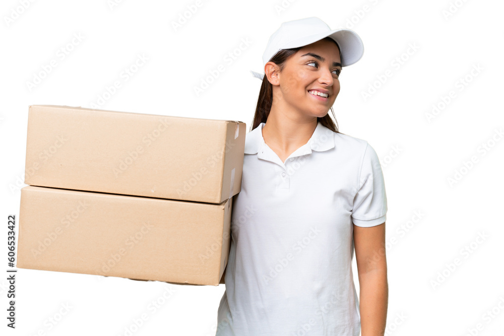 Delivery caucasian woman holding boxes isolated on green chroma background looking side Delivery caucasian woman holding boxes isolated on green chroma background looking side