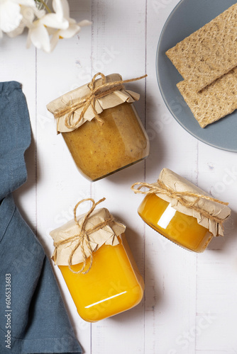 Jars with honey and nuts honey on wooden background top view, flat lay