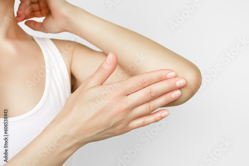 Photography woman applying moisturizer on elbow skin, care for dry elbow skin