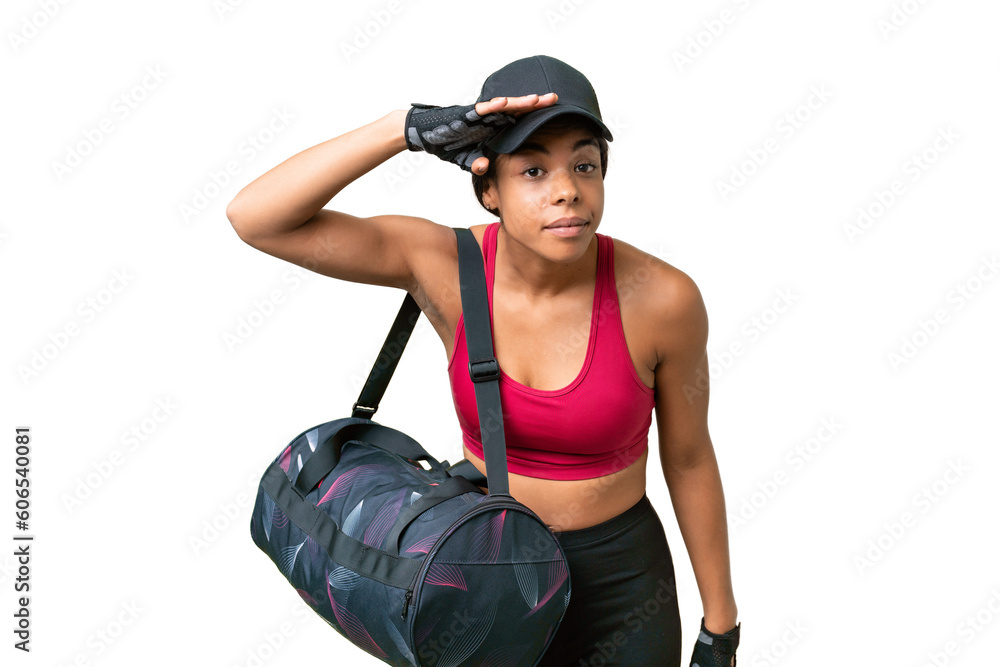 Young sport African american woman with sport bag over isolated background looking far away with hand to look something