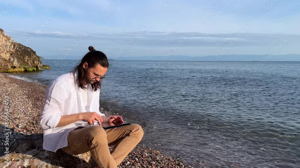 man with the tablet tablet near the sea man with the tablet tablet near the sea
