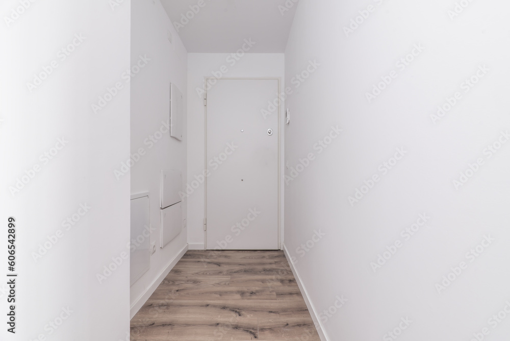 Hallway of a house with white walls and wooden floors Hallway of a house with white walls and wooden floors