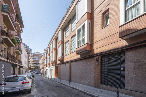 A narrow city street with low-rise buildings © Toyakisfoto.photos