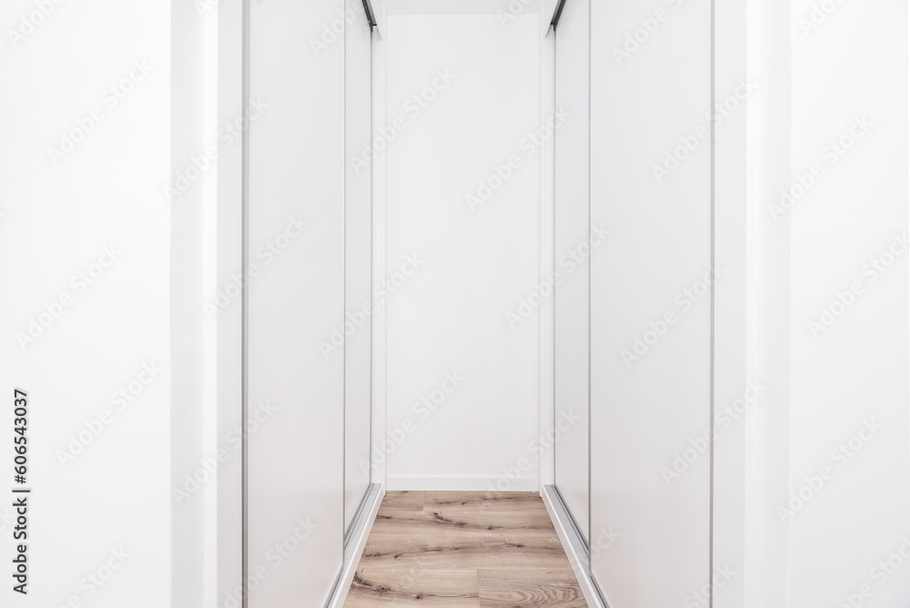 a dressing room with white wooden cabinets a dressing room with white wooden cabinets