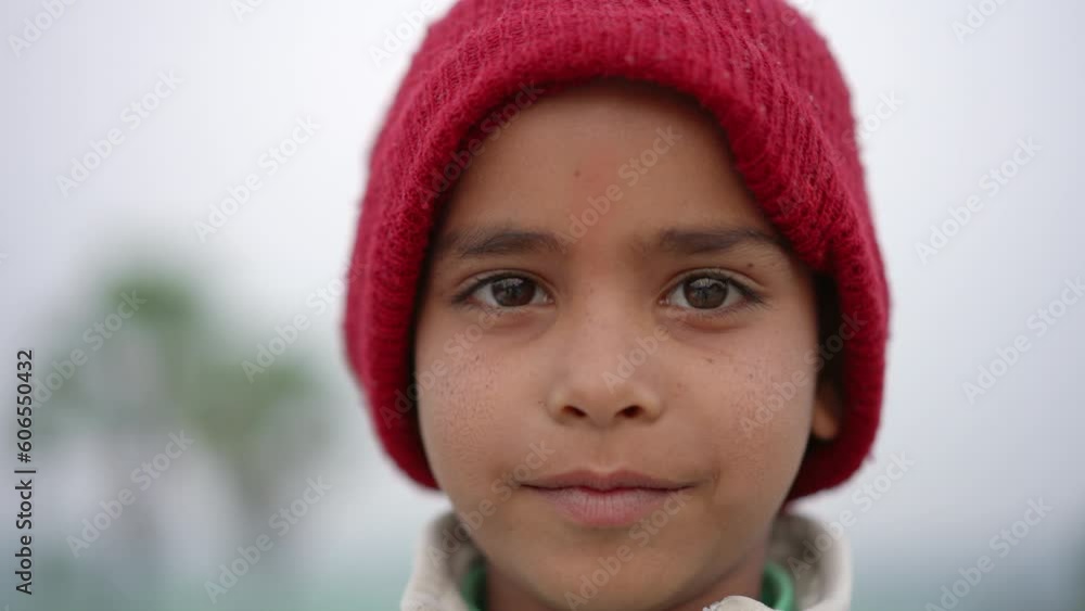 Closeup shot of happy Indian boy looking at camera and smiling in outdoor setting, Indian countryside. Closeup shot of happy Indian boy looking at camera and smiling in outdoor setting, Indian countryside.