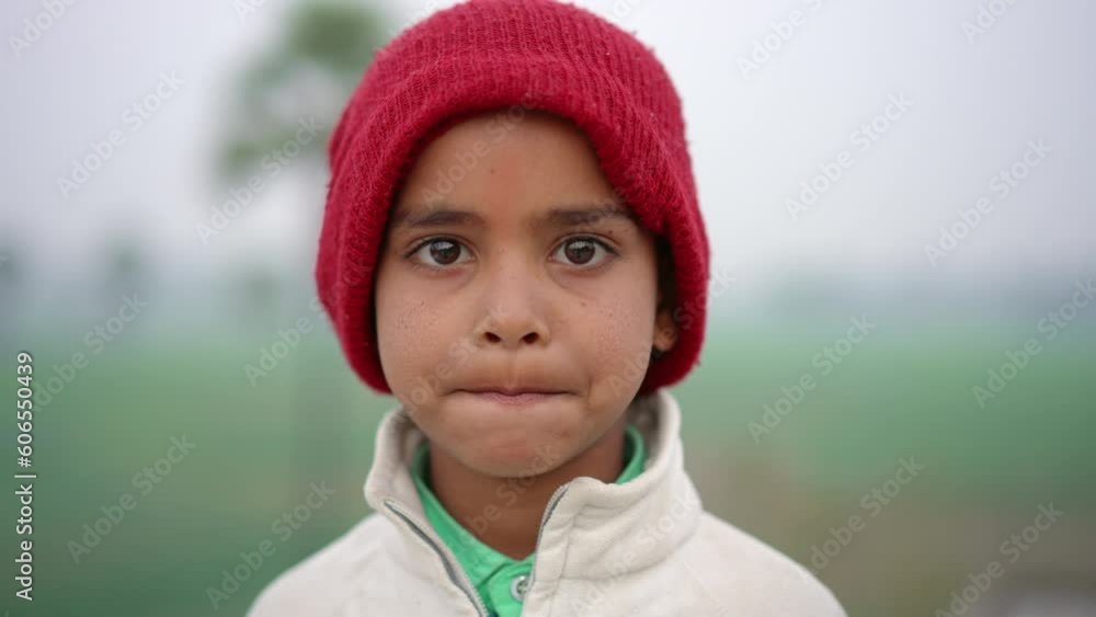 Happy Indian boy looking at camera and smiling in outdoor setting in the Indian countryside. Happy Indian boy looking at camera and smiling in outdoor setting in the Indian countryside.