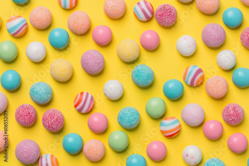 different candy over a yellow studio background with vibrant colors