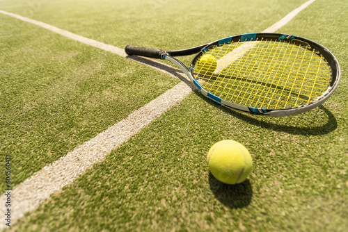 tennis racket with a tennis ball on a tennis court © Angelov