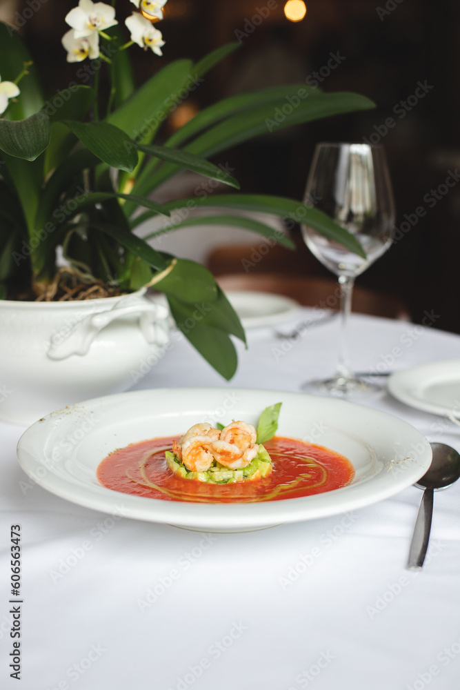 Appetizing Italian soup with seafood in a large white plate. Shrimps, mussels, octopuses. Restaurant serving food. Appetizing Italian soup with seafood in a large white plate. Shrimps, mussels, octopuses. Restaurant serving food.