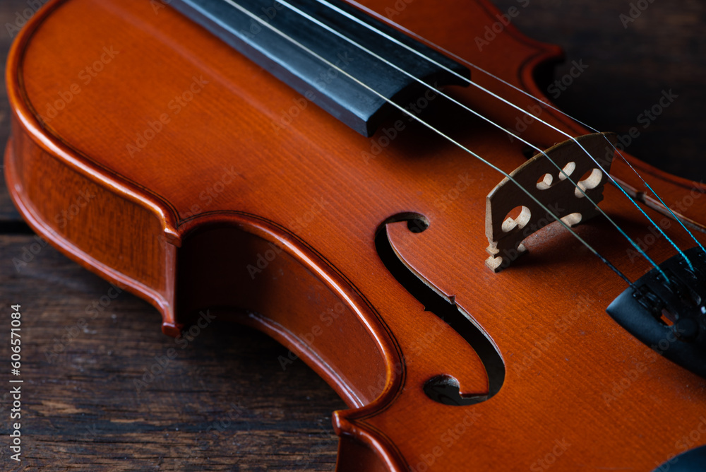 Violin, details of a beautiful violin on rustic wood, low key style photo, black background, selective focus. Violin, details of a beautiful violin on rustic wood, low key style photo, black background, selective focus.