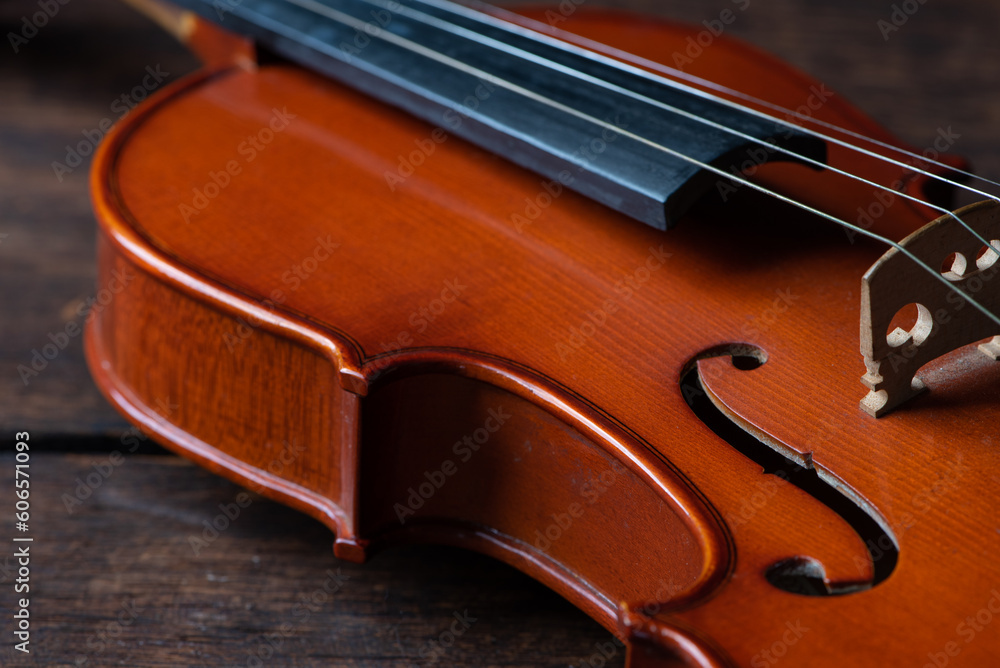 Violin, details of a beautiful violin on rustic wood, low key style photo, black background, selective focus. Violin, details of a beautiful violin on rustic wood, low key style photo, black background, selective focus.
