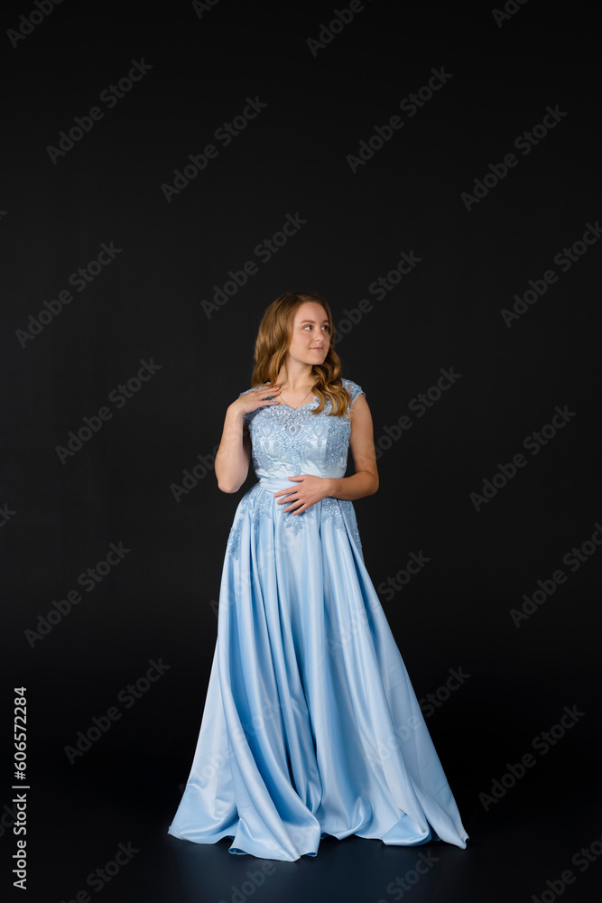 Beautiful young Bridesmaid in blue dress, posing. isolated on black background. Beautiful young Bridesmaid in blue dress, posing. isolated on black background.