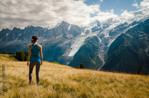 Woman looking out over the Bossons glacier and Mont Blanc in the Chamonix mountains photo