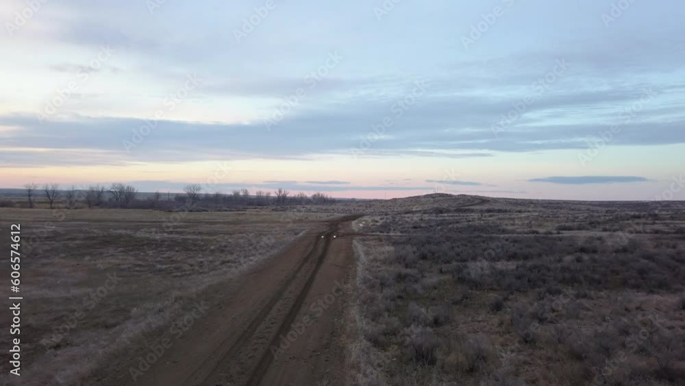 Flying along muddy ranch road with standing water and ruts in prairie gumbo Flying along muddy ranch road with standing water and ruts in prairie gumbo