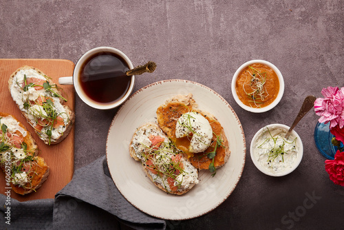 Obraz na plátně Healthy breakfast - Low-Carb Cuisine with sandwiches with Greek yogurt and zucchini spread, poached egg, salmon, coffee cup