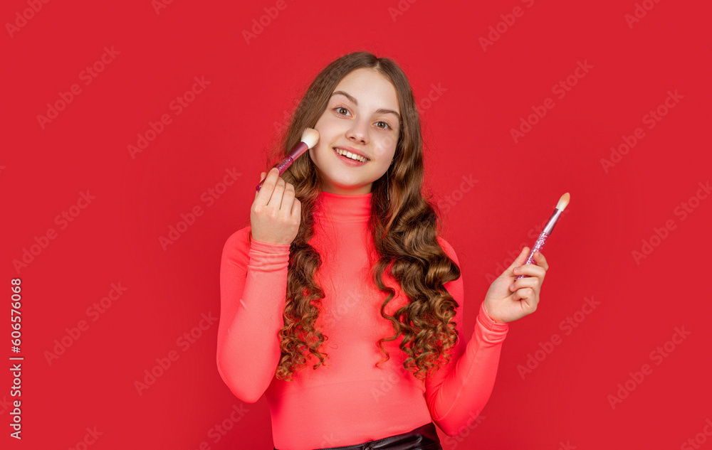 happy teen girl apply powder on face with makeup brush happy teen girl apply powder on face with makeup brush