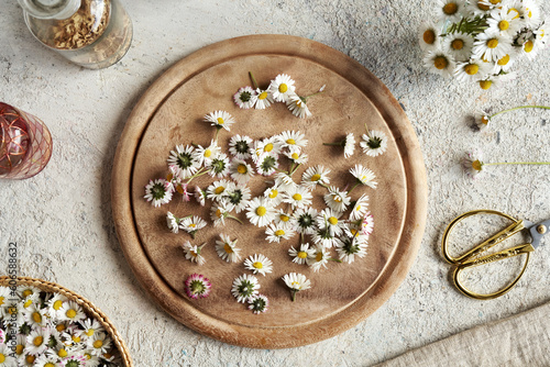 Lawn daisy flowers on a wooden cutting board