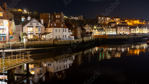 Lights of Whitby reflecting on the water at night.
