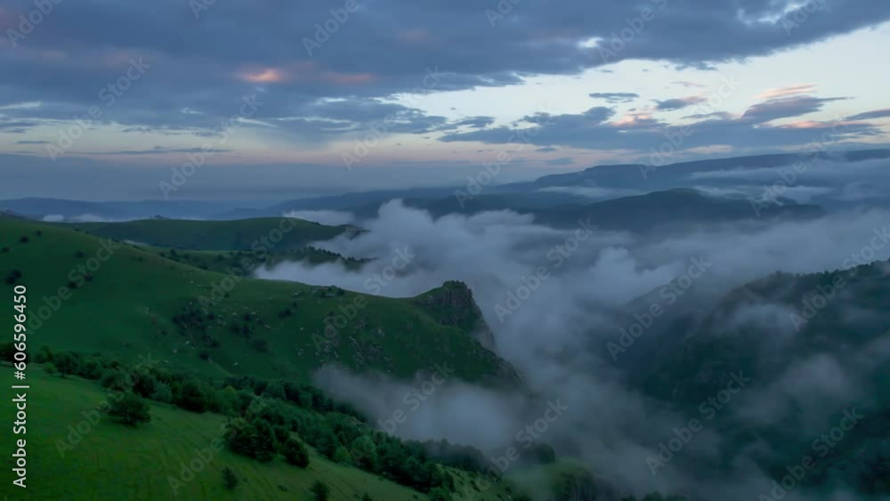 Low clouds in the mountains. Aerial view of low fog in mountainous area Low clouds in the mountains. Aerial view of low fog in mountainous area