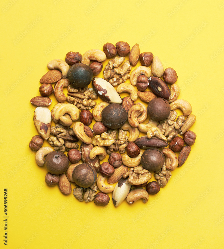 Pattern of nuts mix on yellow background Pattern of nuts mix on yellow background