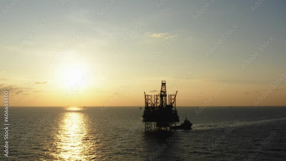 Aerial view of silhouette offshore jack up drilling rig during sunset - oil and gas industry
Aerial view of silhouette offshore jack up drilling rig during sunset - oil and gas industry