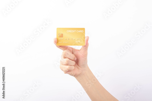 Female hand holding golden credit card on white background.