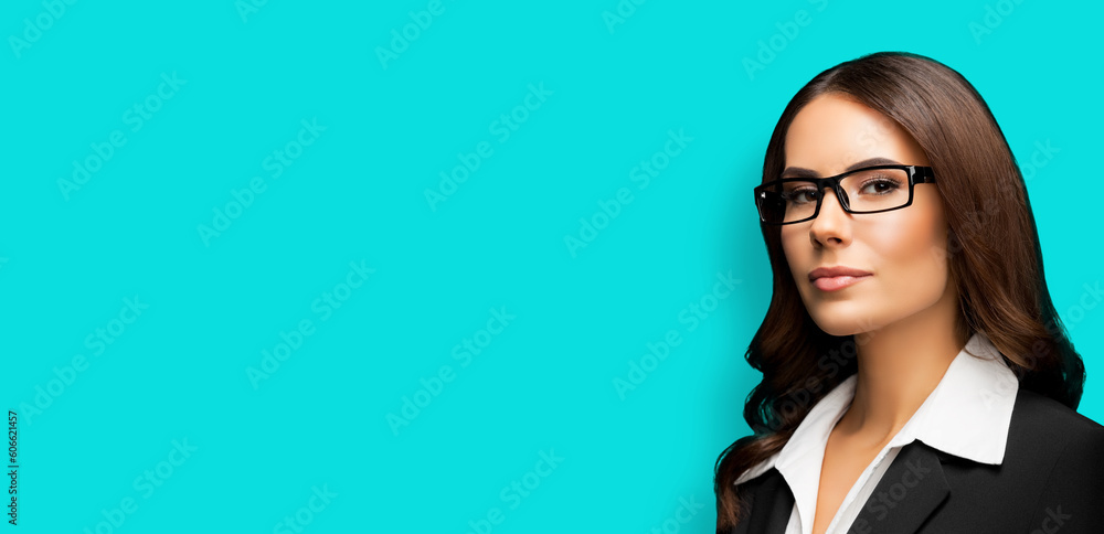 Portrait of happy smiling young businesswoman in eye glasses spectacles, black confident suit, isolated on aqua marine background. Business woman in eyeglasses at studio. Copy space area. Portrait of happy smiling young businesswoman in eye glasses spectacles, black confident suit, isolated on aqua marine background. Business woman in eyeglasses at studio. Copy space area.