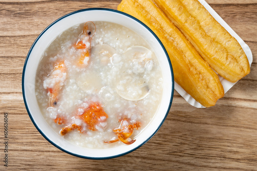 top view seafood porridge with crabs and shrimps and white shells and deep-fried dough sticks horizontal composition
