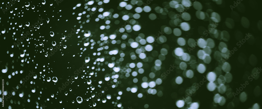 Atmospheric minimal monochrome backdrop with rain droplets on glass. Wet window with rainy drops and dirt spots closeup. Blurry minimalist background of dirty window glass with raindrops close up. Atmospheric minimal monochrome backdrop with rain droplets on glass. Wet window with rainy drops and dirt spots closeup. Blurry minimalist background of dirty window glass with raindrops close up.