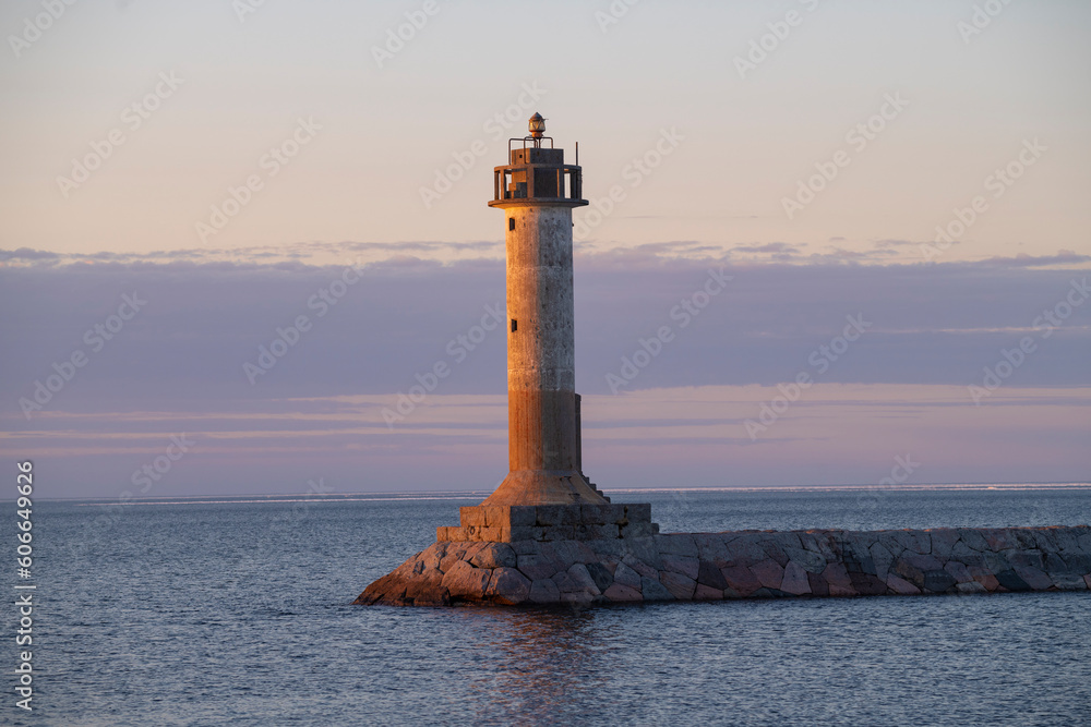 The old Finnish lighthouse Vuohensalo in april twilight. Motornaya Bay, Ladoga lake. Leningrad region, Russia