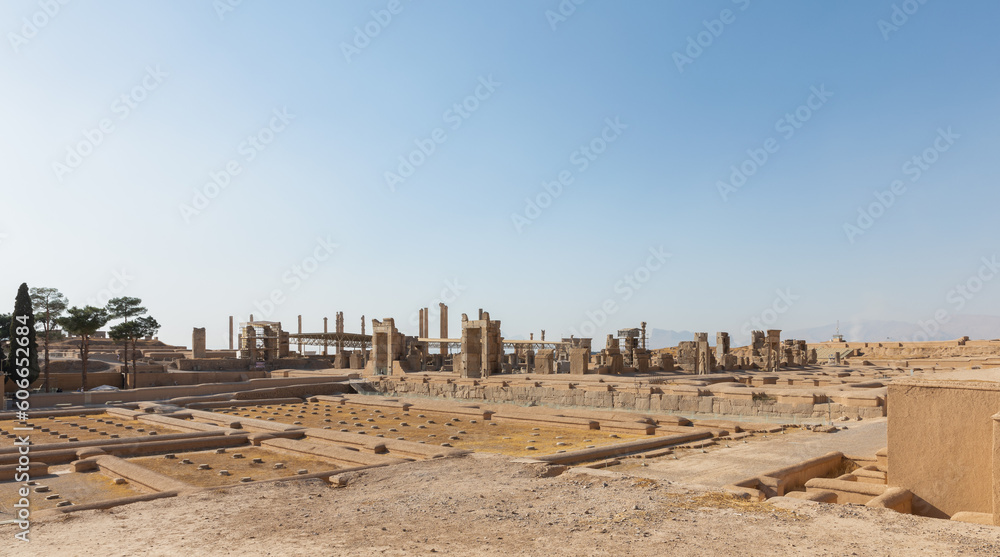 Treasury on left and Ruins of Hall of 100 Columns in Persepolis, founded by Darius the Great in 518 BC and capital of ancient Achaemenid Empire, 60 km northeast of Shiraz, Iran. UNESCO World Heritage.