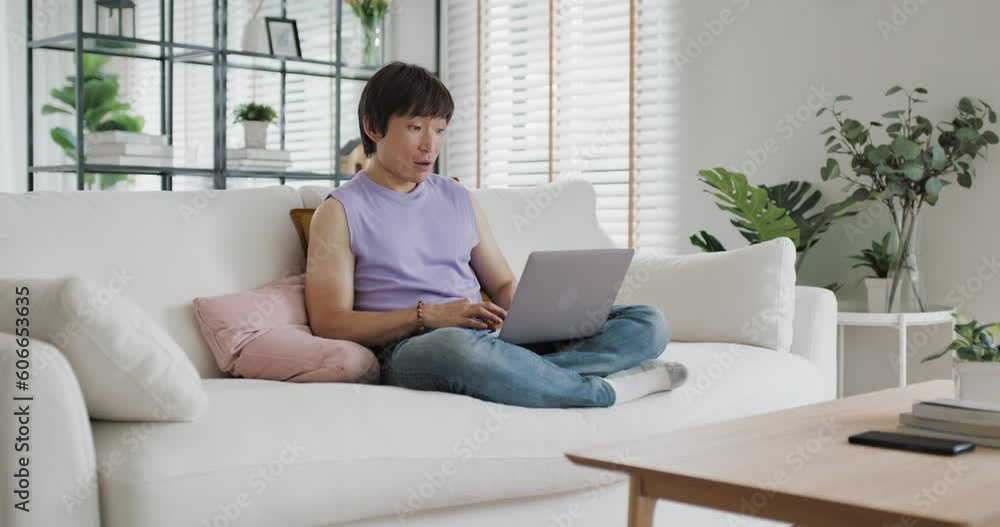 Gen Z queer man non-binary at home. Asia LGBT young guy adult people happy relax sitting at sofa use omni channel easy buy now pay later BNPL shop store. Reading online bank loan news on web page app. Gen Z queer man non-binary at home. Asia LGBT young guy adult people happy relax sitting at sofa use omni channel easy buy now pay later BNPL shop store. Reading online bank loan news on web page app.