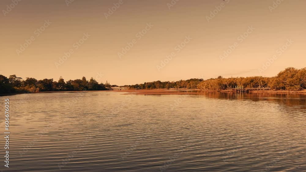 A scene sunset over the calm river and reflection framed by mangrove forest. Coffs Harbour, Australia. A scene sunset over the calm river and reflection framed by mangrove forest. Coffs Harbour, Australia.