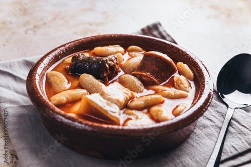 Spanish fabada asturiana on table photo