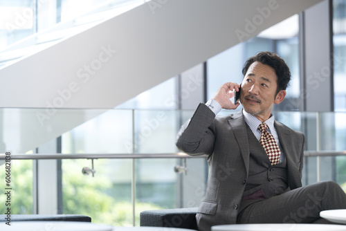 Image of a cool middle class Asian manager or president who calls and contacts you. Copy space available.