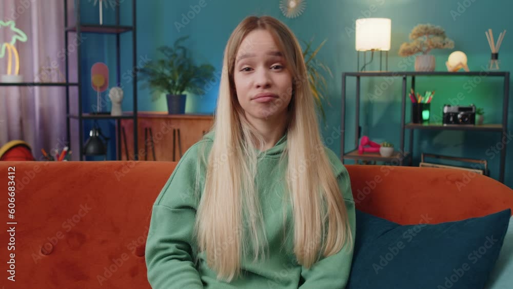 Displeased upset woman reacting to unpleasant awful idea, dissatisfied with bad quality, wave hand, shake head No, dismiss idea, dont like proposal. Young Caucasian girl at home apartment room on sofa Displeased upset woman reacting to unpleasant awful idea, dissatisfied with bad quality, wave hand, shake head No, dismiss idea, dont like proposal. Young Caucasian girl at home apartment room on sofa