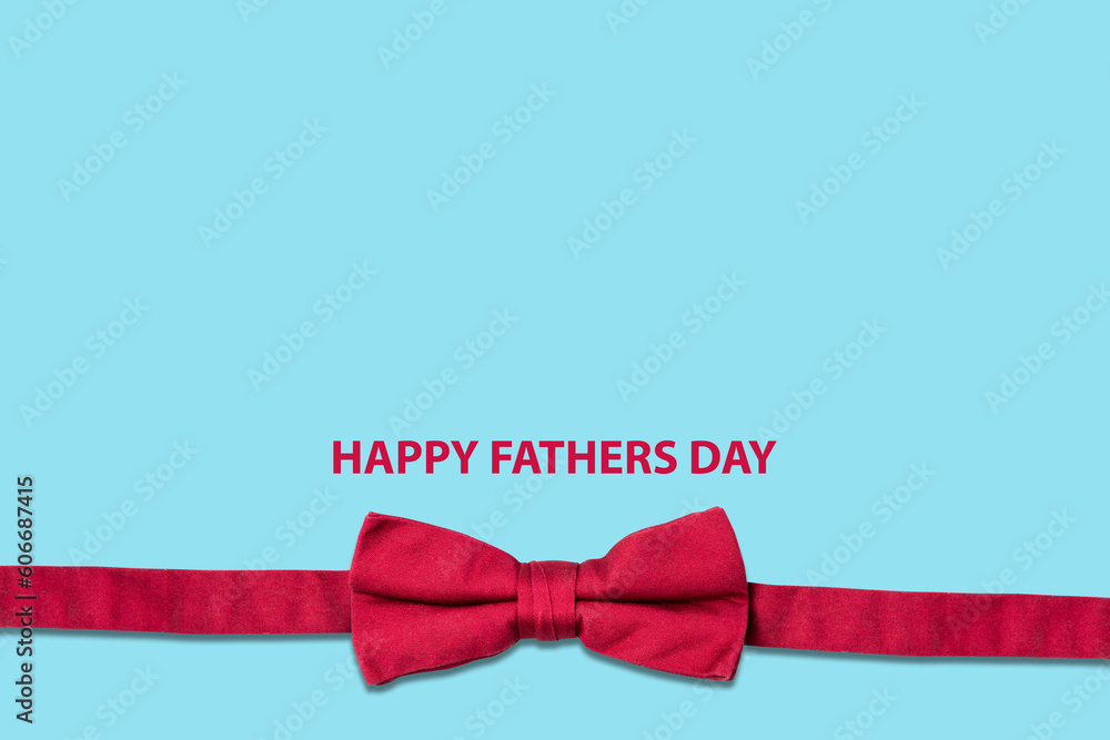 Happy Father's Day. Bow Tie, and words on a blue background. Copy space. Father's Day Concept. Festive background. Happy Father's Day. Bow Tie, and words on a blue background. Copy space. Father's Day Concept. Festive background.