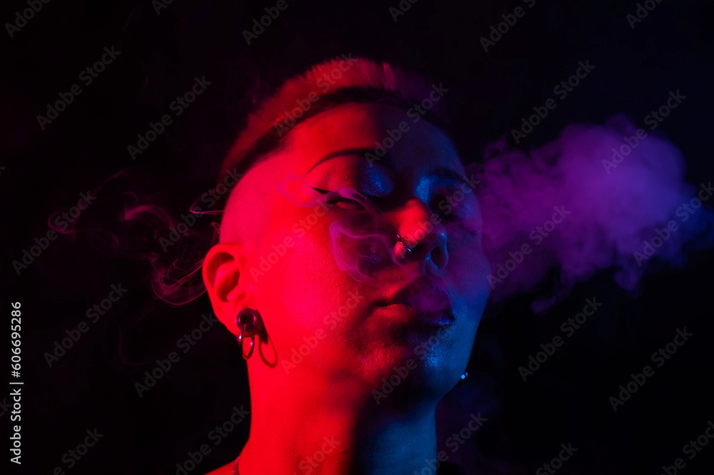 Close up portrait of asian woman with short hair smoking in neon light. Close up portrait of asian woman with short hair smoking in neon light.