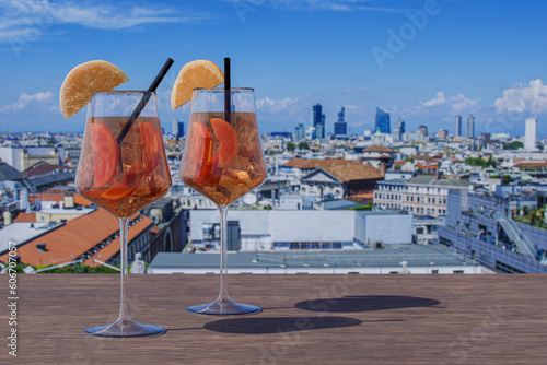 Two Spritz cocktails on a table with view of Milan, Italy