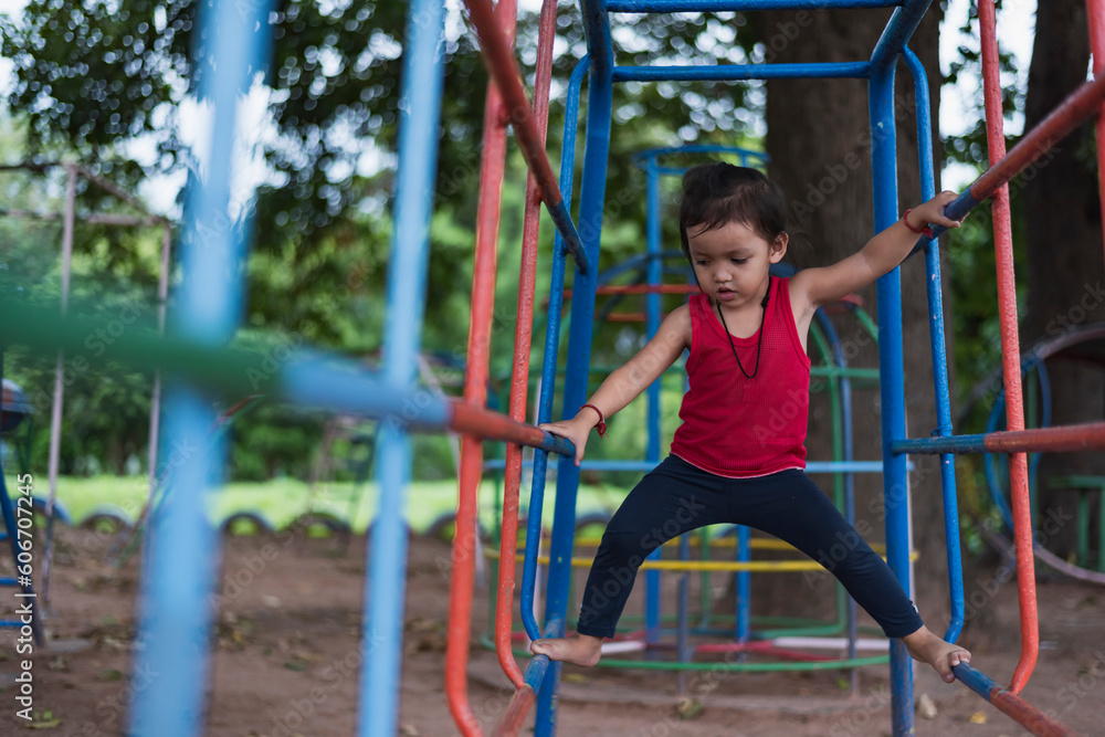 Fototapeta premium Kids playing on outdoor playground, kids playing in school or kindergarten, kids active on colorful slides and swings, healthy summer activities for kids.