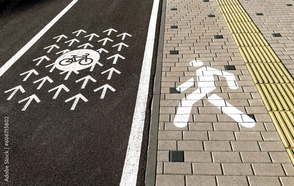 Fototapeta premium Dividing line, marking between bicycle and pedestrian roads, lanes
