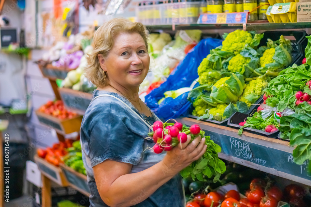 Senior woman selecting fresh vegetables on Market