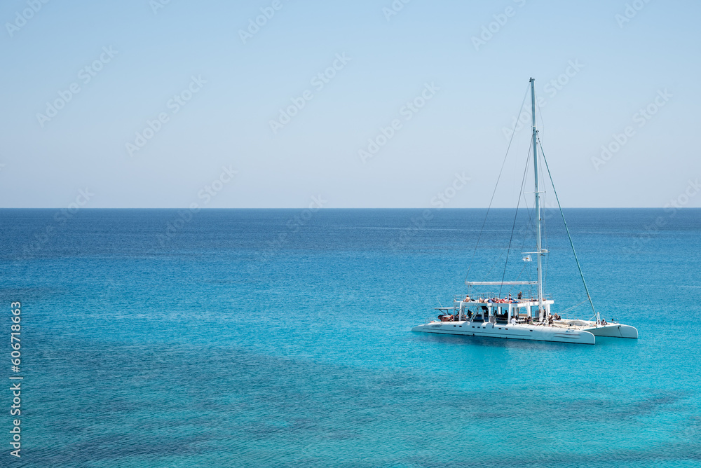Tourist yacht sailing in the sea with tourists enjoying summer holidays. Summer vacations. Cape Grego Cyprus Tourist yacht sailing in the sea with tourists enjoying summer holidays. Summer vacations. Cape Grego Cyprus
