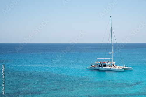 Tourist yacht sailing in the sea with tourists enjoying summer holidays. Summer vacations. Cape Grego Cyprus